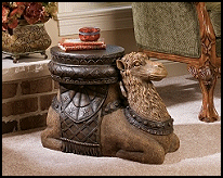 Add an exotic accent to home or gallery with this work of decorative art cast in 16 lbs. of quality designer resin, richly textured and hand-painted in desert shades. Ready to serve as a free-standing sculpture, table, footstool or display stand, this stylized camel will willingly bear your burdens anywhere in your home
