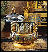 Images of Egypt's royal boy king gather in an artistic synergy of style and function to be admired from all angles. Shown to true advantage beneath a 31-inch diameter, pencil-edged, 3/8" thick, quality glass top, this richly hand-painted, quality designer resin work of decorative art boasts the colors of the Egyptian palette highlighted in faux gold leaf.