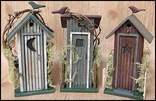 wood outhouses come in assorted styles. Each one has vine, moss & wire accents.