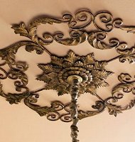 Dress the ceiling in a swirl of acanthus leaves as you showcase your spectacular chandelier with this ornate ceiling medallion. Beautifully handcrafted of iron with tole accents, it has a hand painted light burnished gold leaf finish. The gorgeous Old World design of this piece will put the finishing touch on your room. This ceiling medallion is sold by ultra-luxe retailers